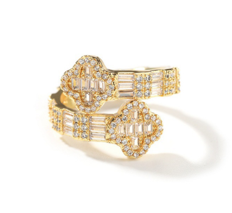 Gold ring with diamond accents on a white background